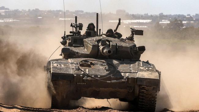 An Israeli army battle tanks moves along the border with the Gaza Strip in southern Israel on May 7, 2024, amid the ongoing conflict between Israel and the Palestinian Hamas movement. (Photo by Menahem KAHANA / AFP)