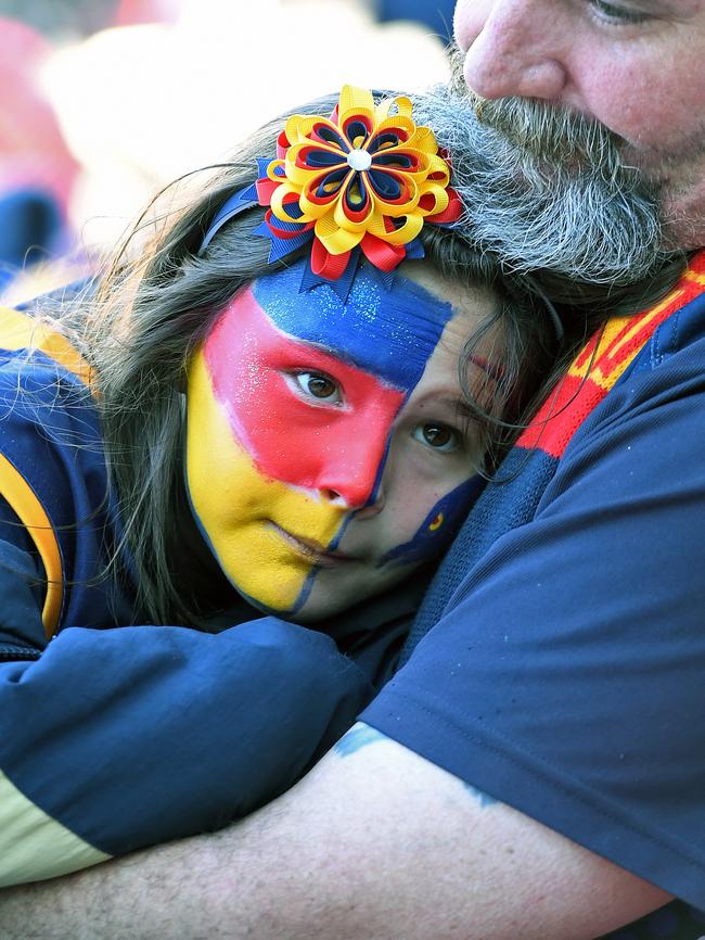 Hannah Murphy, 8, is comforted with a much-needed hug. Picture: Tom Huntley