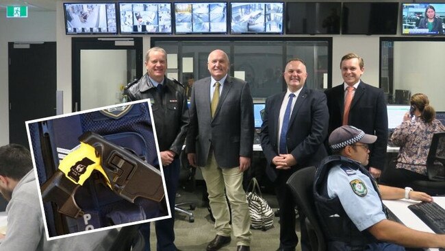 Police Minister David Elliott (second from left) will review the use of tasers after lobbying from Brisbane Water Superintendent Tony Joyce.