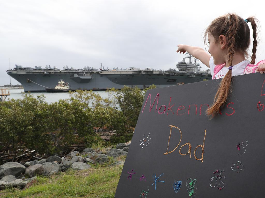 Makenna Klein (6) waves at the ship looking for her dad. The USS Ronald Reagan arrives in Brisbane. Pic Peter Wallis