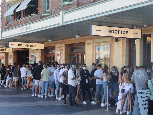 People were out enjoying the sun at Manly Beach today on the first weekend after cover lockdown ended. Pictured is the line to get in the Steyne Hotel on the Corso. Picture: David Swift