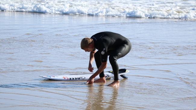 Champion surfer Mick Fanning shows off his inner conservationist by rescuing a fish stranded on a Gold Coast beach. Photo: Leisa Oakes @natures_jewel