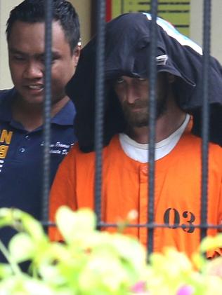 David Taylor escorted by police for interrogation at Denpasar Police Station. Picture: Lukman S. Bintoro.