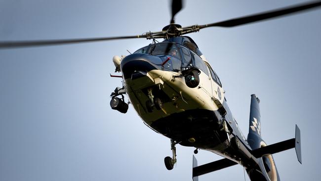 A police chopper involved in the search for the Stoccos. Picture: Mike Keating.