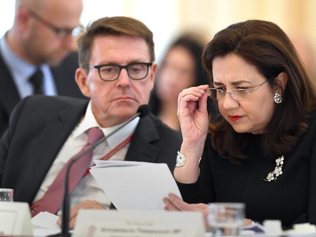 Director-General of the Department of the Premier and Cabinet Dave Stewart (left) looks on as Queensland Premier Annastacia Palaszczuk studies a document during an Estimates Hearing. Picture: AAP Image/Dave Hunt