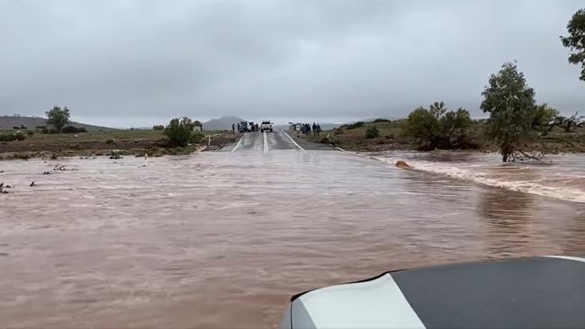 Stuart Livingstone crossing a flooded road just outside of Hawker on the way to Parachilna, Picture: CCIASA/Stuart Livingstone