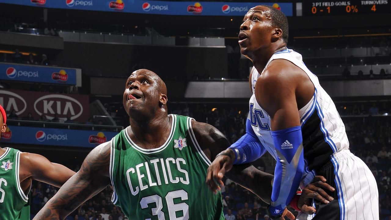 ORLANDO, FL - DECEMBER 25: Dwight Howard #12 of the Orlando Magic battles for position in the paint against Shaquille O'Neal #36 of the Boston Celtics on December 25, 2010 at the Amway Center in Orlando, Florida. NOTE TO USER: User expressly acknowledges and agrees that, by downloading and or using this photograph, User is consenting to the terms and conditions of the Getty Images License Agreement. Mandatory Copyright Notice: Copyright 2010 NBAE (Photo by Fernando Medina/NBAE via Getty Images)