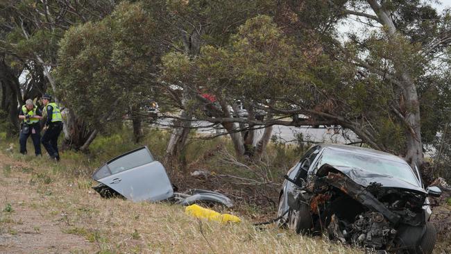 The wreck of the car showing the downed pole, after the crash at Waterloo Corner. Traffic has been diverted. Picture: Dean Martin