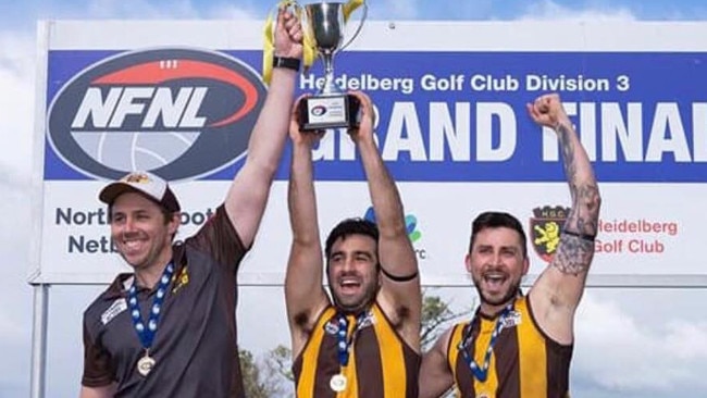 Heidelberg West reserves coach Michael Missen and co-captains Stefan Condello and Jason Butera raise the premiership trophy.