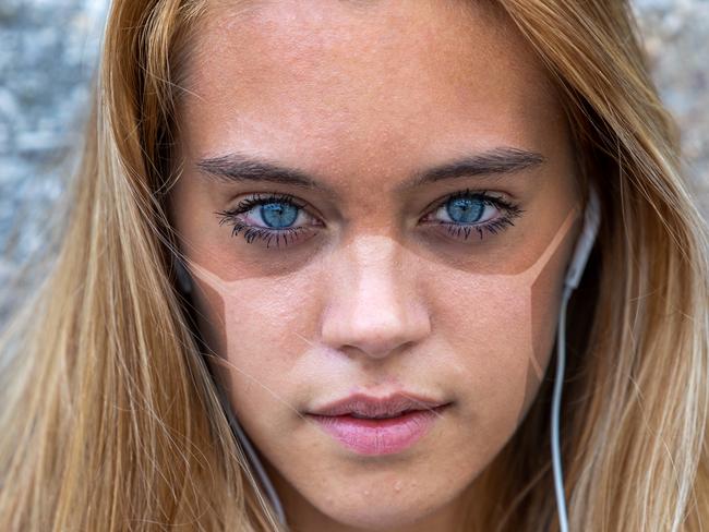 beautiful young woman with tan lines caused by a surgical mask maybe used under lockdown or social distancing for coronavirus COVID19 or another disease