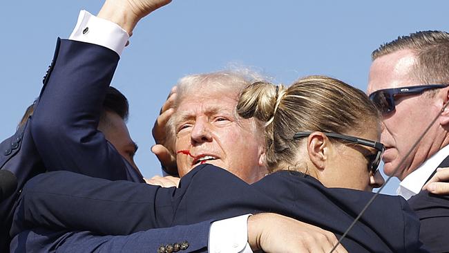 Trump was seen with blood above his right ear and was quickly escorted off stage by Secret Service personnel; he is reportedly ‘fine’ and receiving medical attention. Picture: Anna Moneymaker/Getty Images/AFP