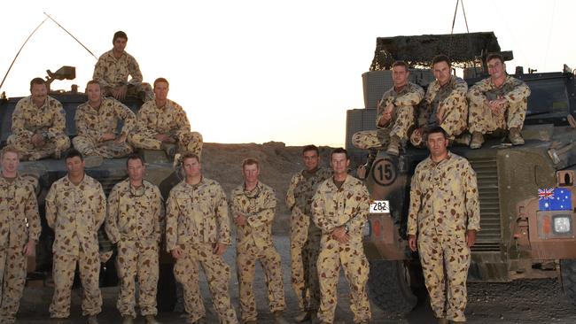 Daniel Keighran (fifth from left in front row) with soldiers from the 6th Battalion of the Royal Australian Regiment at Camp Smitty, Iraq. Jared MacKinney is in the middle row, second from left.