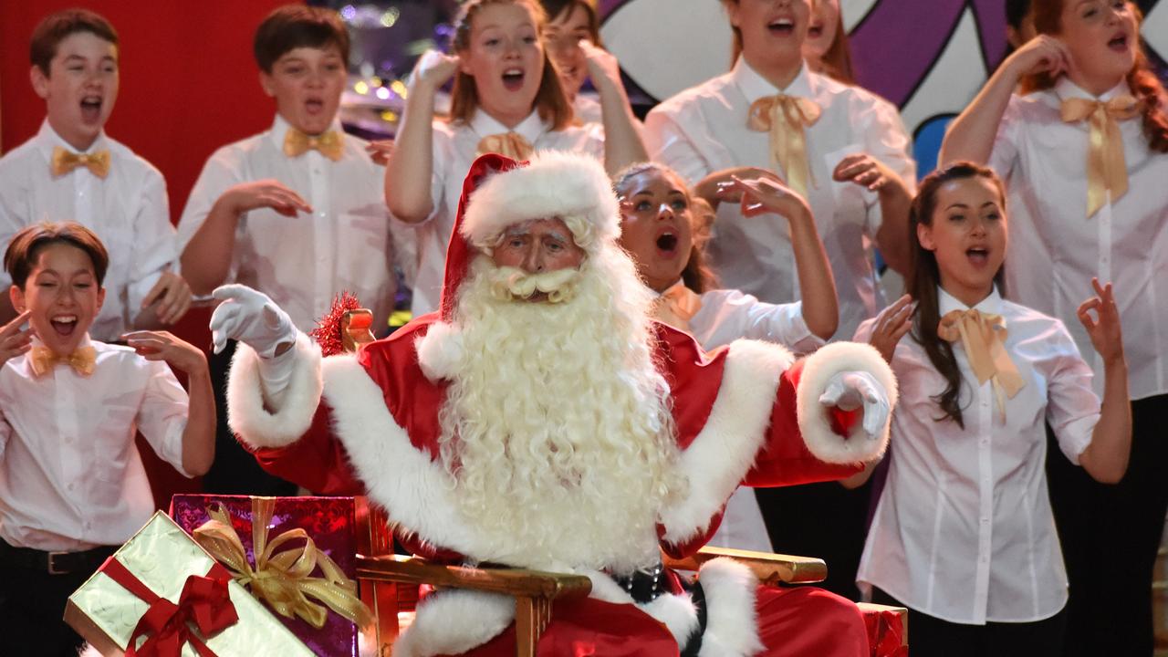 Santa with carollers at Carols by Candlelight in Melbourne. Picture: Tony Gough