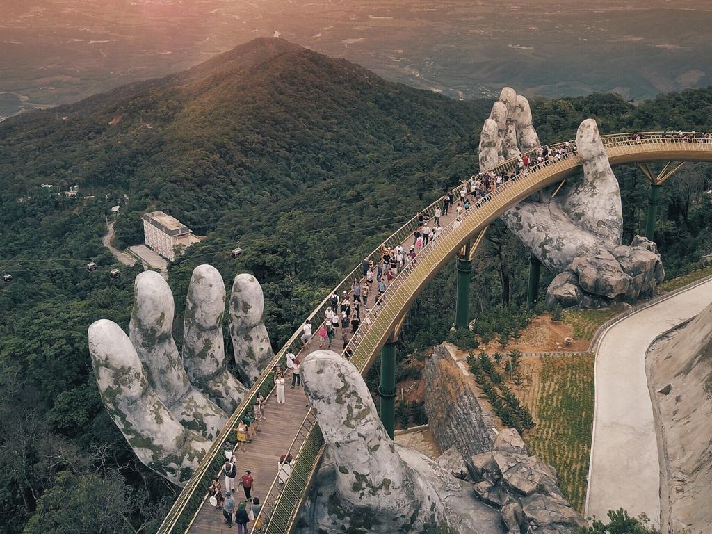 <p><b>CAU VANG / GOLDEN BRIDGE: </b>Vietnam’s latest drawcard is a man-made wonder: A dramatic pedestrian bridge providing views across the Ba Na hills near Danang. Its name means “golden bridge” - but it’s not the colour that’s the most striking part of the structure, rather the giant pair of hands reaching out from the hillside to support it.</p>