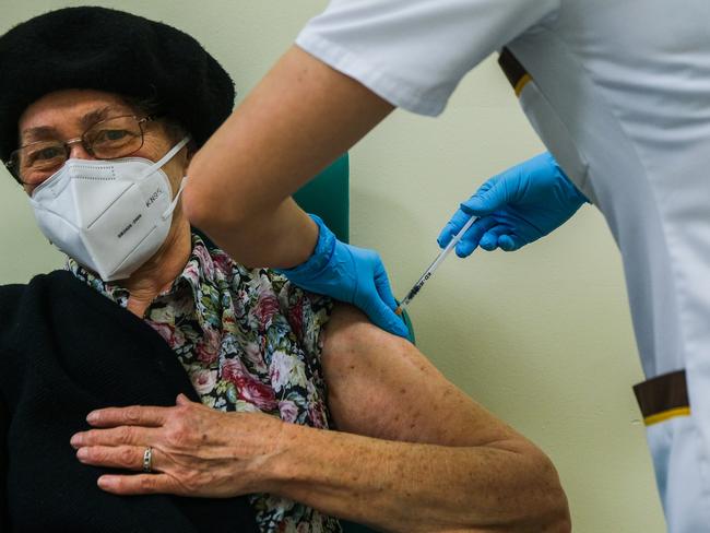 A health worker gives a Pfizer jab to an elderly woman at in Poland. Picture: Getty Images