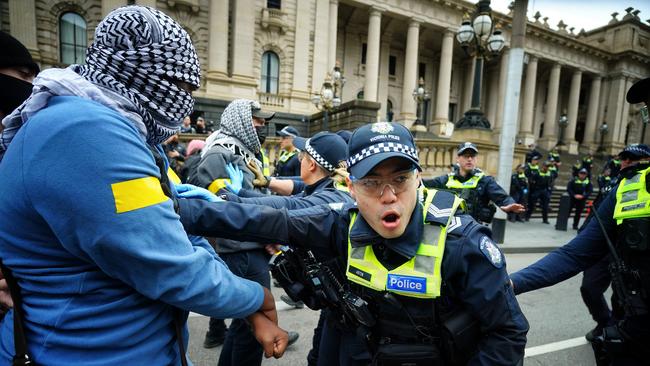 Pro-Palestinian protesters face off with police outside the Victorian Parliament. Picture: NCA NewsWire / Luis Enrique Ascui