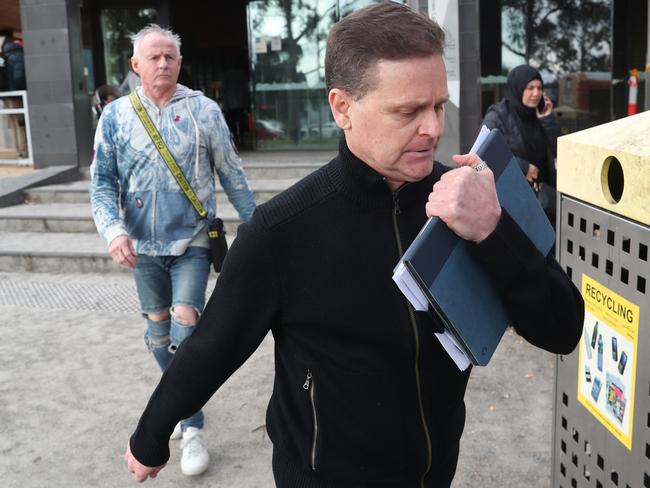 Jockey Danny Nikolic (front, in black) leaving the Broadmeadows Magistrate Court.