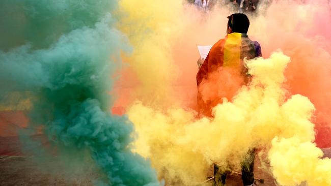 Coloured flares are seen during the lesbian, gay, bisexual and transgender Pride Parade in Pristina, Kosovo, on October 10, 2019 (Photo by Armend NIMANI / AFP)