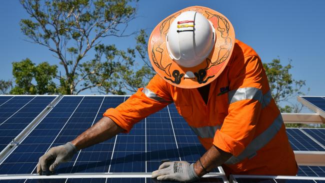 A Northern Territory worker installs solar panels. Picture: Lucy Hughes Jones/AAP
