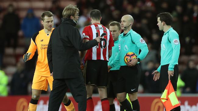 Jurgen Klopp, Manager of Liverpool confronts referee Anthony Taylor.