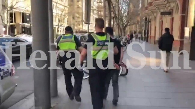 Police arrest man at Collins St bank
