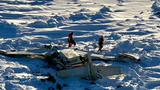 This image obtained from the US Coast Guard (USCG) on February 7, 2025, shows the remains of a plane reported missing February 6. The Bering Air Caravan was carrying nine passengers and one pilot on board. The search ended after the aircraft was located some 34 miles (55kms) southeast of Nome, Alaska. The USCG reported the three individuals were found inside and were deceased. "The remaining 7 people are believed to be inside the aircraft but are currently inaccessible due to the condition of the plane," according to a statement posted on the X of the USCG. (Photo by Handout / US Coast Guard / AFP) / RESTRICTED TO EDITORIAL USE - MANDATORY CREDIT "AFP PHOTO / US Coast Guard" - NO MARKETING NO ADVERTISING CAMPAIGNS - DISTRIBUTED AS A SERVICE TO CLIENTS