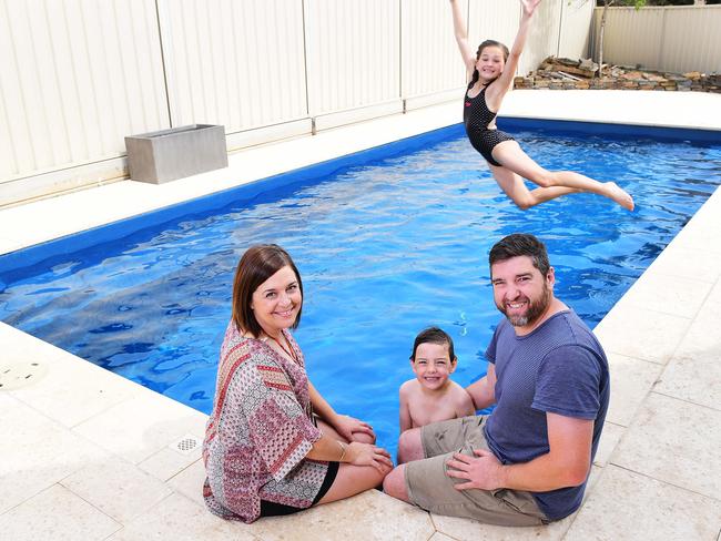 BETTER EFFICIENCY: Matt and Emma Nicholas enjoying their new pool at Grange with children Maeve and Tate. Picture: MARK BRAKE/AAP