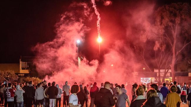 Schoolies at Rye throw flares. Picture: Jason Edwards