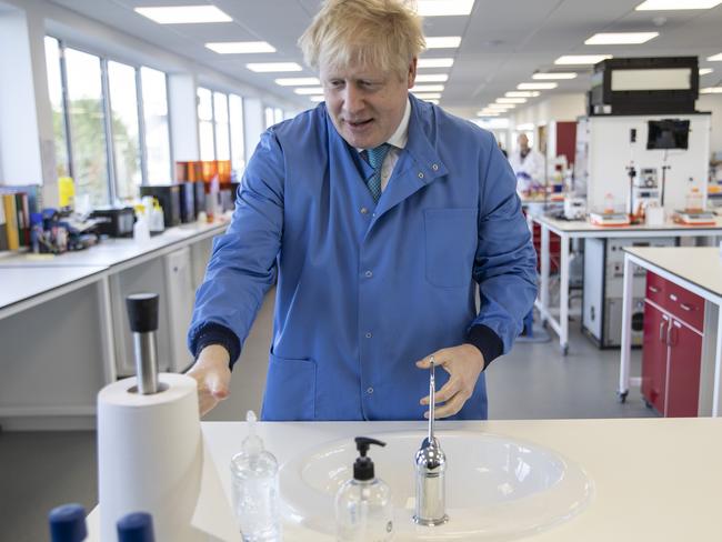 UK Prime Minister Boris Johnson washes his hands during a visit to the Mologic Laboratory in Bedford, England. Picture: WPA Pool/Getty Images