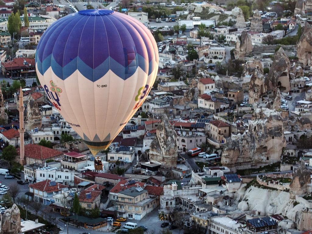 Tourists take in the view over the town of Goreme during a hot air balloon ride on April 17, 2016 in Nevsehir, Cappadocia, Turkey. Picture: Getty