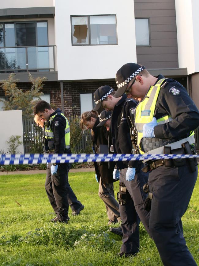 Police scour the crime scene in Ascot Vale where Dank’s home was shot at. Picture: David Crosling