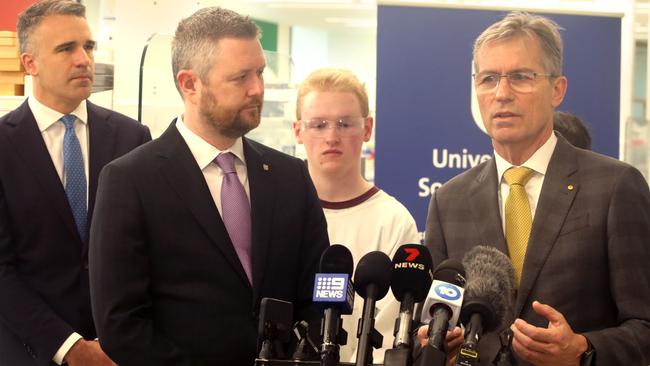 ADELAIDE, AUSTRALIA - NewsWire Photos July 3, 2023: SA Premier Peter Malinauskas, University of Adelaide Vice Chancellor, Prof Peter Hoj AC (R) & University of SA Vice Chancellor Prof David Lloyd visit Uni SA's Bradley Lab to hold a press conference regarding the proposed merger of the two universities. (Adelaide Uni student Caleb Lill in background) Picture: NCA NewsWire / Dean Martin