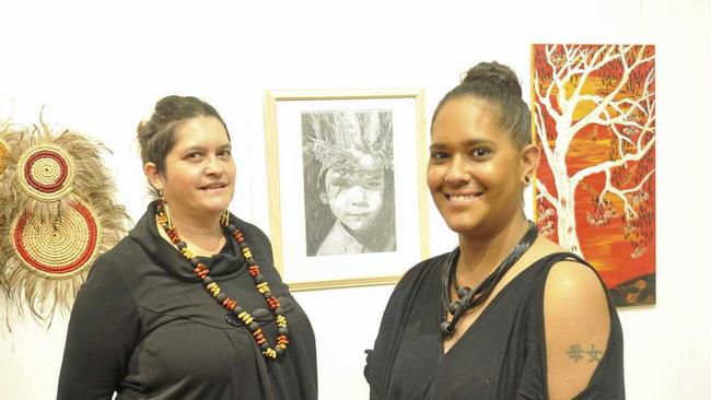 EXQUISITELY EXECUTED: Exhibition judge Bianca Beetson and art prize winner Stacie Fraser with her work  Daughter of a Warrior  in the background. Picture: Tim Jarrett