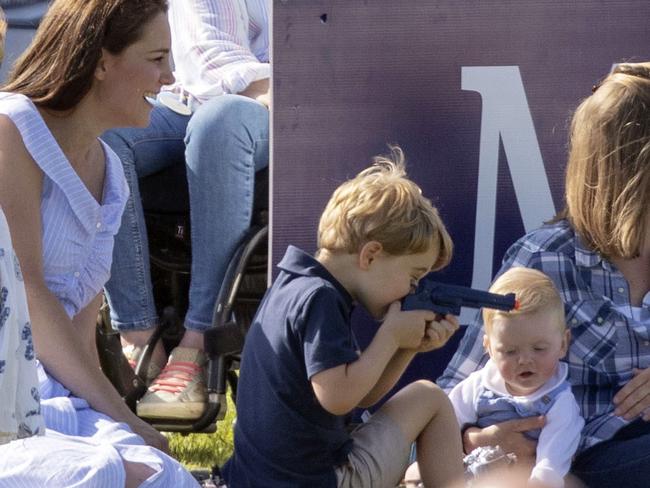 The Duchess of Cambridge sits with Prince George at a charity polo match. Picture: Steve Parsons/PA via AP