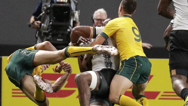 Wallaby winger Reece Hodge goes flying after his contact with Peceli Yato. Picture: AP