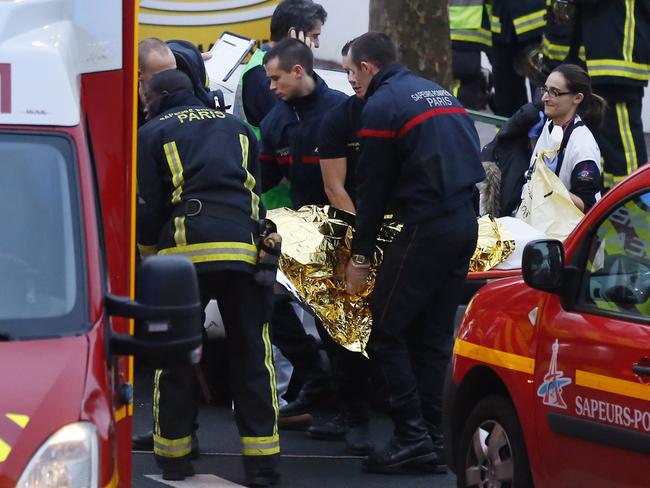 Rescue service workers and firefighters tend to injured people in the second Paris shooting. Picture: Thomas Samson