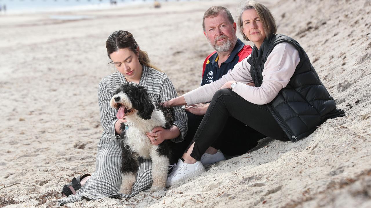 Chelsea Ireland’s parents Greg and Debra and sister Maddie with Chelsea&#039s dog Buddy at Semaphore Beach. Picture: Tait Schmaal.