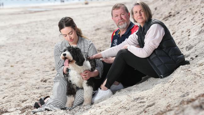 Chelsea Ireland’s parents Greg and Debra and sister Maddie with Chelsea's dog Buddy at Semaphore Beach. Picture: Tait Schmaal.