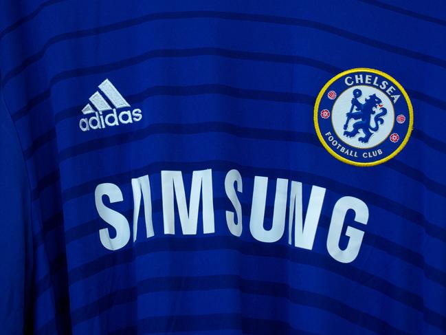 A Samsung Electronics Co. sponsorship logo sits on a Chelsea Football Club soccer shirt inside the Adidas AG store at the company's headquarters in Herzogenaurach, Germany, on Thursday, March 3, 2016. German sport-shoe maker Adidas forecast sales and earnings to increase as much as 12 percent this year as consumers spend more ahead of the Euro 2016 soccer tournament. Photographer: Krisztian Bocsi/Bloomberg via Getty Images