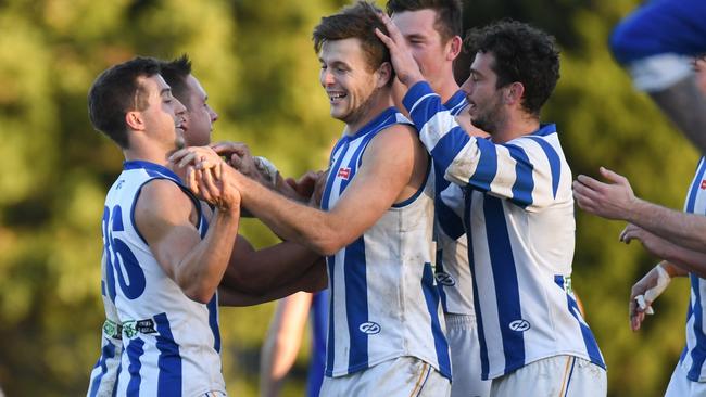 Macleod's Patrick Martin is mobbed by teammates after kicking one of his seven majors. Picture: Nathan McNeill.