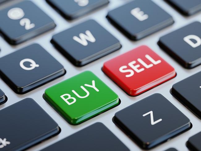 Modern computer keyboard with buy and sell buttons and copy space. Horizontal composition with selective focus. Great use for investment, forex and savings related concepts.