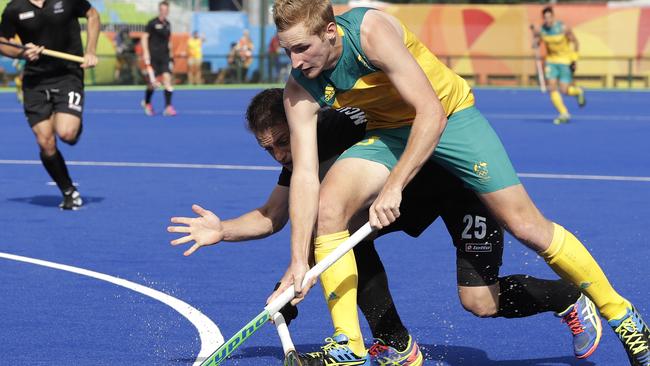 Australia's Daniel Beale, foreground, fight for the ball against New Zealand's Shea McAleese, background, during a men's field hockey match at 2016 Summer Olympics in Rio de Janeiro, Brazil, Saturday, Aug. 6, 2016. (AP Photo/Hussein Malla)