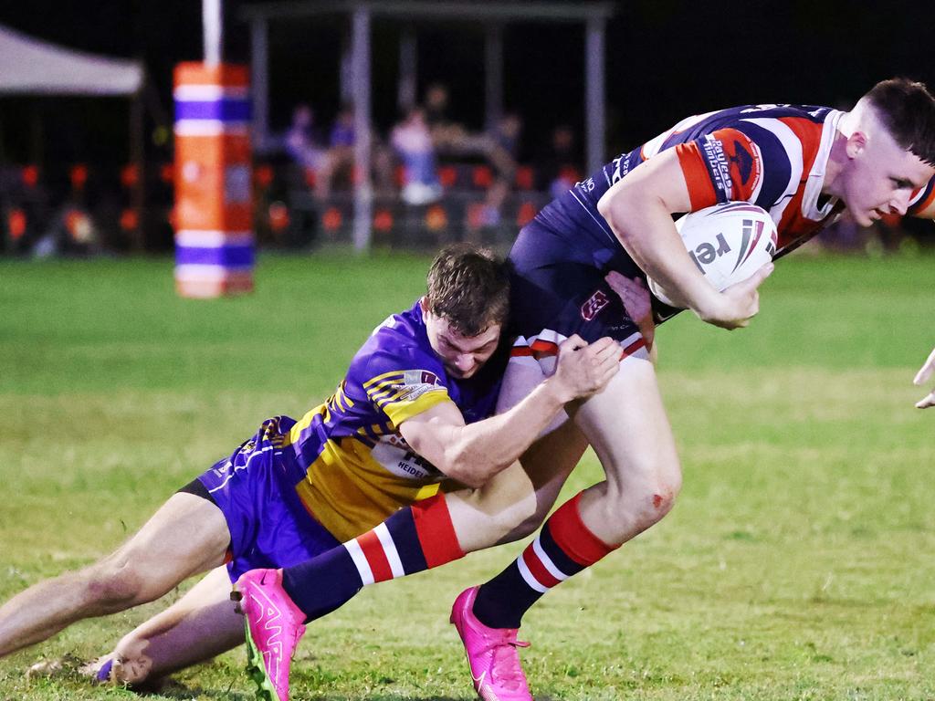 Roosters' Lachlan West is tackled by Roos' Malique Douthat in the Far North Queensland Rugby League (FNQRL) Men's minor semi final match between the Atherton Roosters and the Cairns Kangaroos, held at Smithfield Sporting Complex. Picture: Brendan Radke