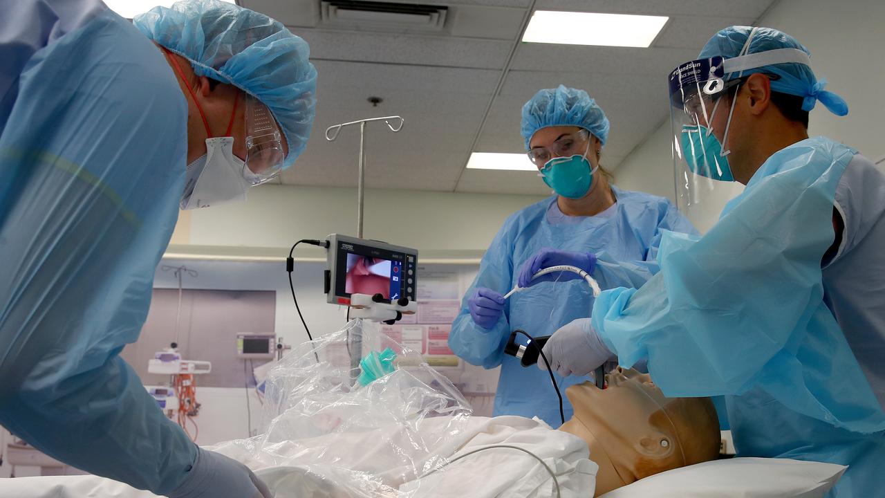 Medical staff in a training simulation lab at Westmead in April prepared for different scenarios of patients suffering with coronavirus. Now hospital admissions for COVID-19 have dropped dramatically. Picture: Toby Zerna