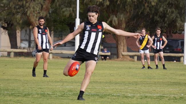 Merbein's Josh Carmichael kicks one of his goals against Red Cliffs in the Sunraysia league, at Dareton. Picture: Michael DiFabrizio