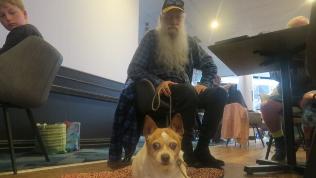 Dennis Scott and his dog at Port Panthers evacuation centre. Picture: Daniel Mills