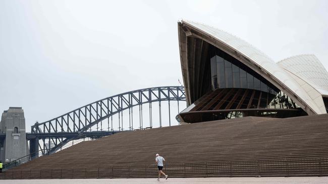 A runner outside the Sydney Opera House, as the city enters its third week in lockdown. Picture: NCA NewsWire / James Gourley