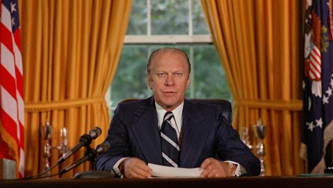 US President Gerald Ford reads a proclamation on September 9, 1974, granting former president Richard Nixon a pardon.