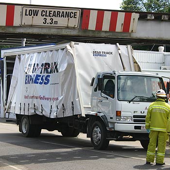 Truck stuck under Nambour rail bridge | The Courier Mail