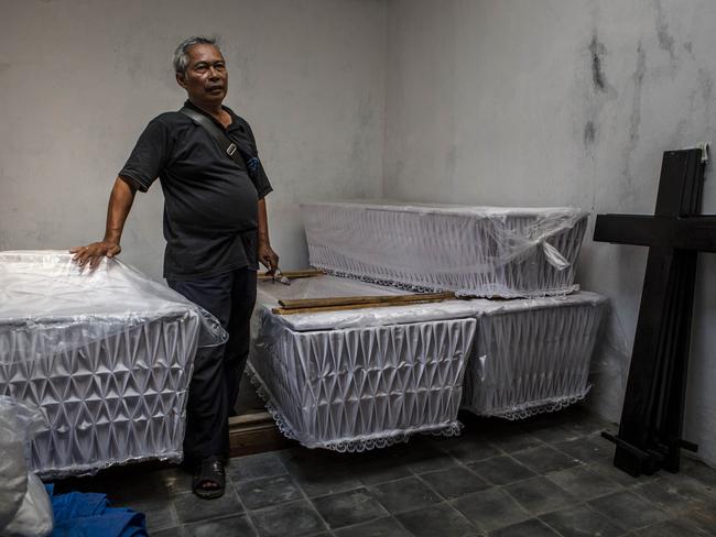 Suhendro Putro prepares coffins at Java christian church on February 18, 2015 in Cilacap, Central Java, Indonesia. Picture: Getty